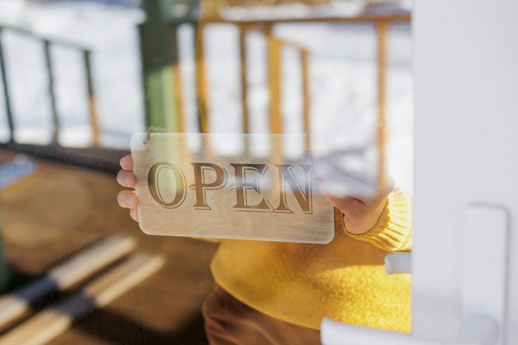 sign on door with inscription open or closed. wooden sign on door of restaurant or coffee shop